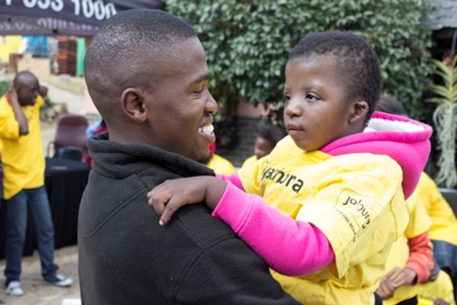 Elly Majola of Zinto spends time with a disabled youth at Sithandiwe Disabled Care Centre in Lombardy East