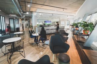 Tenants of a flexible office space enjoy a break in the coffee shop. 