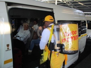 While waiting for their transport to arrive on a cold winter morning, commuters are offered a hot cup of coffee