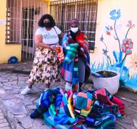 Thandanani House of Refuge caretaker, Claudia Masewawtla, receiving knitted blankets from Randridge Mall’s Marketing manager, Siphelele Sokhela (on the left).