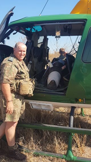 Don English SANParks Regional Ranger with the rhino calf in the helicopter