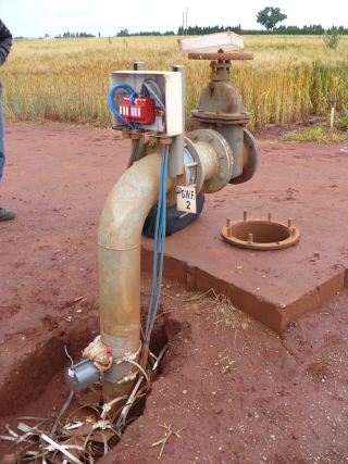 A borehole outlet pipe being fitted with earthing and surge protection units housed in the junction box