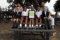 Above: Grade 1 pupils and teachers sit on the new picnic bench made from recycled plastic that they received as their prize in Plastic SA’s Clean-up and Recycle Competition 2016, whilst they were proudly showing off their certificate.