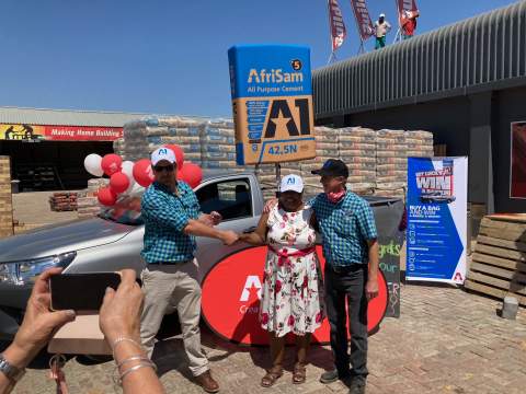 Harry van der Schyff and Martin Nuttal from Pula BuildIt, celebrating with Pauline Nhlapo. 