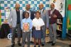 Left to right Terence Delomoney(GM King Shaka), Paul Makhanya (SED Specialist King Shaka), Siyabonga Lushozi ( DOE District Manager) and Colin Naidoo(Senior Manager Corporate Affairs) together with kids from beneficiary schools