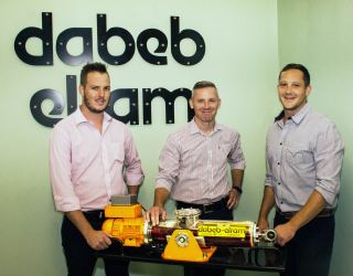 Stuart Palmer (Production Manager, Dabeb-Engineering), Freddie Kühn (Regional Manager, Hytec) and Nathan Pearce (Executive Director, Dabeb-Engineering) with a model of the DEA range of electro-hydraulic actuators.