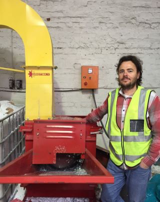 Hilton Cowie of Greenlite Concrete with the hammermill installed on his premises by the PSPC to assist with the processing of the large volumes of post-consumer polystyrene