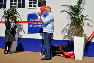 Ribbon-cutting ceremony. Pictured at the official launch of the Kwikspace                         Learning Academy in May 2018 are Kwikspace CEO Deon Fuhri (cutting the                         ribbon) and Kwikspace Human Resources Executive Thabisa Moleshe.