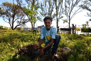 Charles Gxala from TransCape NPO planting a tree for Husqvarna and Mdumbi Green Fair Musical Festival