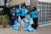 Claude Boni, far left, and Door of Hope staff with the donation from OSTI