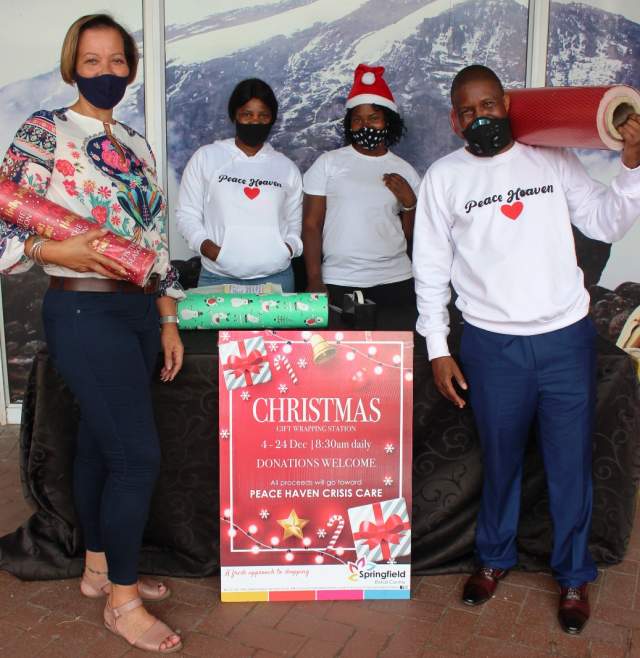 LEND YOUR SUPPORT TO THE PEACE HAVEN CRISIS CARE UNIT!: Bernice Clarisse (The Property Manager under the Broll Property Group) with the Peace Haven Crisis Care Unit team, Mavis Ndimande, Melody Chataka and Pastor Sibusiso Ndimande on standing ready to wrap that gift for your loved one!