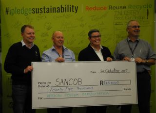 Above (fltr): Dr Stephen van der Spuy (SANCCOB), Douw Steyn (Plastics|SA),Mariette Hopley (SANCCOB) and Charles Muller (Packaging SA) during the cheque handover at the recent Propak Cape Exhibition. Behind them is the pledge wall where companies and individuals who donated money to the seabird hospitals could sign their names.