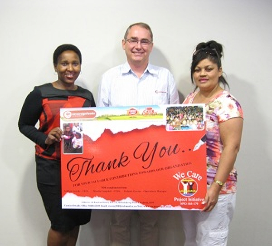 We Care CEO Ashlene Arends (right) hands over thank you placard to Sovereign Foods’ CEO Chris Coombes (middle) and Group Executive HR Thuto Shongwe (left)