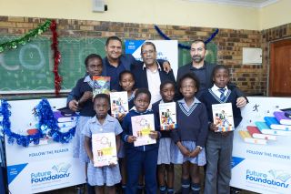 Audi Arendse(Novus Holdings), Louis Taylor(Director Dept. Basic Education DBE) and Ahmed Motala (New Africa Education Foundation) with the delighted learners at Nyiko Primary