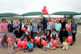 Prize winner, Aaron Matumbike celebrates his amazing with the staff and pupils of Trinityhouse Little Falls Pre-Primary.