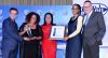 Winning smiles (L-R): Imraan Noorbhai, Standard Bank KZN Provincial Head hands Stella Khumalo,  the CEO uShaka Marine World her winning trophy while Lalita Dhasiar-Ventura (KZN Top Business) and Mpume Mabuza, the marketing director at uShaka Marine World holding their winning certificate; Grant Adlam (KZN Top Business)  