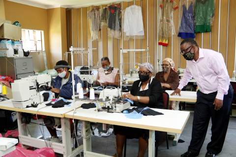 Dorcas Foundation situated in the Ethafeni Multi-Skill Centre in Tembisa with members, Patricia Mbatha (front left), Maggie Mabuza (front right), Maria Mohlala (back left) and Annah Macheke (back right) are pictured hard at work making some of the 23 052 masks  produced to date for Tembisa schools while Emperors Palace Trust Administrator, Makomane Ntabo looks on during a recent visit.