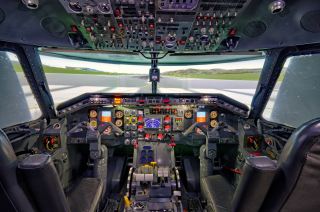 The cockpit interior of the Embraer 120 simulator. The rudder pedals are situated on the floor below the instrumentation and the flight controls are positioned directly in front of each seat. The conversions, implemented for software compatibility purposes, pertain to the controls directing inflight aircraft angles (side-slip and shade), the aircraft roll (side-to-side inflight movement) and pitch (altitude increase/decrease). 	