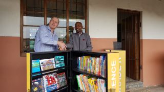 Craig Cowgill of the Bettye Bouye Yates Foundation handing over the resources to proud Principal Zamani Ngidi