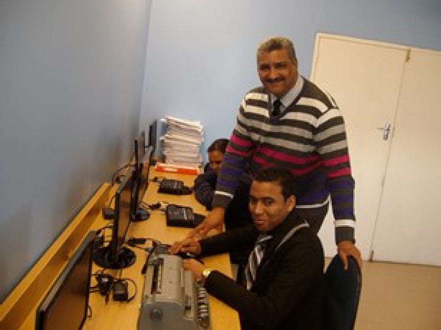 Athlone School for the Blind principal Fletcher Fisher, Edit Microsystems&#039; Kyle Williams and a learner in the computer lab.